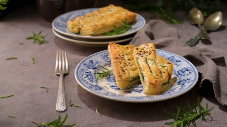 A rustic charm unfolds with a savory spinach pie on a vintage plate.