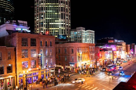 Photo for Nashville, Tennesee - January 21, 2023:  Street scene from famous lower Broadway in Nashville Tennessee viewed at night with lights, historic honky-tonks, bars and restaurants. - Royalty Free Image