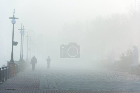Photo for Unidentifiable figures of people in heavy fog - Royalty Free Image