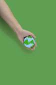 Earth Day concept. Cookie in shape of Earth in hand. Stickers #707726840