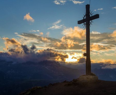 cross at the top of the hillsummit cross on the top of mount Col di Lana, evening sunset view