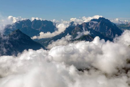 Dolomites mountains in the middle of Clouds, Carnian Alps mountains, Italy