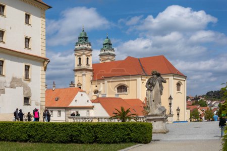 VALTICE, CZECH REPUBLIC - MAY 7th 2023: Baroque church of the Assumption of the Virgin Mary at Freedom Square at sunny summer day, UNESCO world heritage, popular travel destination