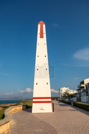 Small Lighthouse on promenade. Can Picafort Beach, evening with no people, Balearic Islands Mallorca Spain. Travel agency vacation concept.