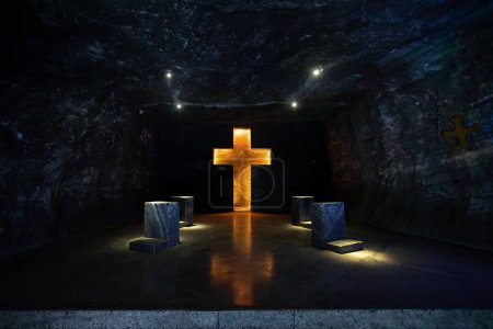 Photo for Illuminated cross representing stations of the cross, illustrate the events of Jesus last journey glows with spiritual light in the underground Catedral de Sal (Salt Cathedral) of Zipaquira, Colombia. - Royalty Free Image