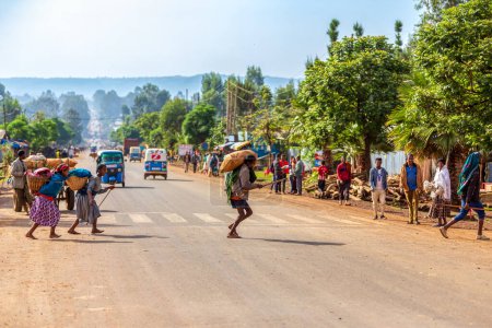 Photo for DEMEBECHA, ETHIOPIA, APRIL 20.2019. People walking on the Ethiopian street in the morning. Demebecha, Amhara Region Ethiopia, April 20. 2019 - Royalty Free Image