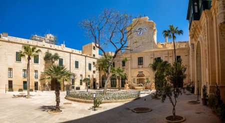 Historic Grandmaster's Palace courtyard with impressive architectural details and traditional Maltese stonework in Valletta. Cultural heritage of Malta