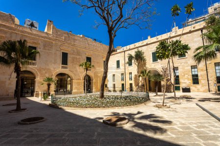 Historic Grandmaster's Palace courtyard with impressive architectural details and traditional Maltese stonework in Valletta. Cultural heritage of Malta