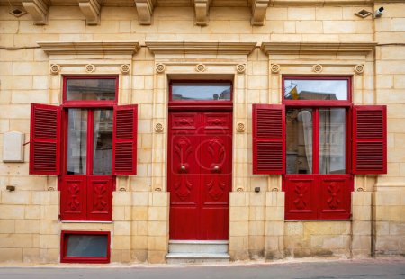 Traditional Maltese house lining narrow streets in Zabbar, adorned with colorful doors and windows, capturing the essence of local architecture and culture. Malta travel destination.