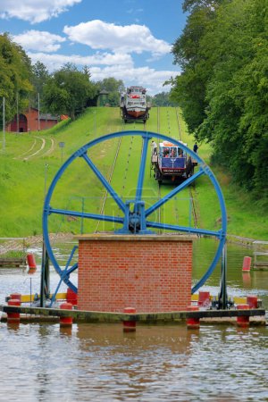 Photo for Poland, Elblag Canal, Masuria Province - 04.08.2023: famous landmark of Warmian-Masurian, Poland. Navigable waterway,boat is hauled and transported on the platform cart to overcome the difference in water levels. - Royalty Free Image