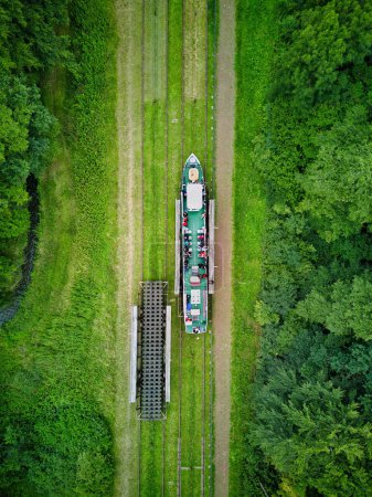 Photo for Poland, Elblag Canal, Masuria Province - 04.08.2023: famous landmark of Warmian-Masurian, Poland. Navigable waterway,boat is hauled and transported on the platform cart to overcome the difference in water levels. Aerial view - Royalty Free Image