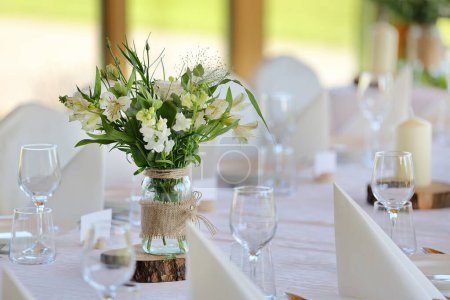 Photo for White flowers decorated on the table for event party or wedding reception - Royalty Free Image