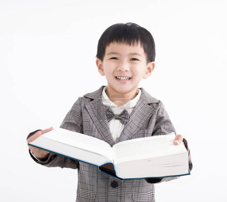 Photo for Happy kid holding and studying book - Royalty Free Image