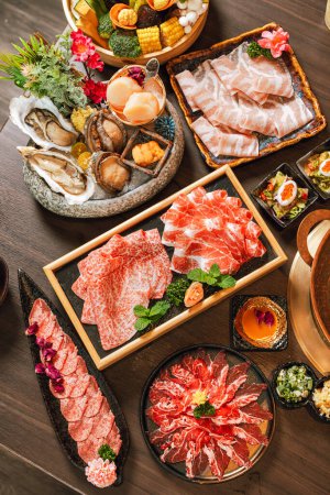 Photo for Seafood cuisine plate and beef sliced meat for hot pots. pork slices, scallops,  seashells, oysters, caviar and other seafood delicacies. - Royalty Free Image