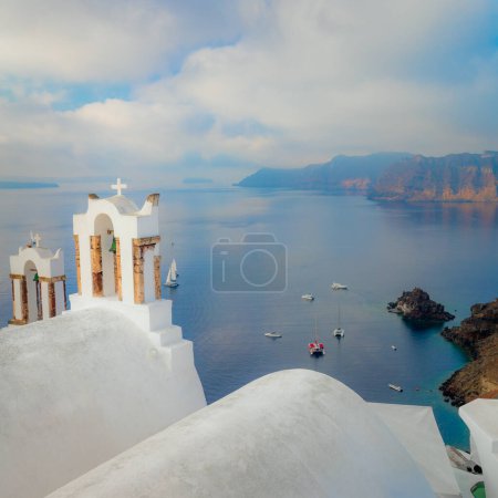 Photo for Santorini, Greece. Conceptual composition of the famous architecture of Santorini island. White bell arch and blue sea view with boats. Santorini island, Greece, Europe. Santorini minimalist photo collection - Royalty Free Image