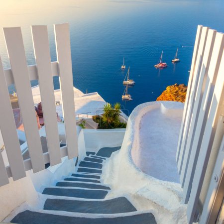 Photo for Gate to heaven. Santorini, Greece. White architecture, open doors and steps to the blue sea of Santorini. Holidays in Greece, Santorini. - Royalty Free Image