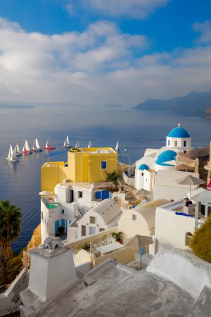 Photo for Santorini, Greece. The famous view of the sights of Santorini - white houses, blue domes and yachts in the azure sea. Santorini island, Greece, Europe. - Royalty Free Image