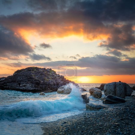 Photo for Seascape. Sea Ocean Wave hit the rock at beach, sea water splash up to the sky with sun. Sunset Sundown at Sea. Storm. Seascape. - Royalty Free Image