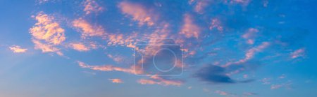 Photo for Panorama of the real sky at sunset time with pink light clouds. Gentle color of dawn, sunset. Large photo format - Royalty Free Image