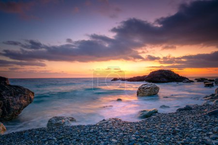Photo for Sea Ocean.  Sunrise time at the sea.  Big roks. Wave hit the rock at beach, sea water splash up to the sky with sun. Sunset Sundown at Sea. Storm. Landscape. Seascape - Royalty Free Image