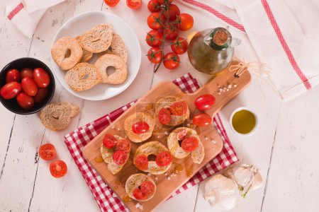 Photo for Friselle with cherry tomatoes and olive oil. - Royalty Free Image