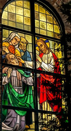Photo for Kalety Miotek, Poland, January 1, 2023: Stained glass windows in the church of St. Francis, seen from the outside in the evening. Healing the blind, - Royalty Free Image