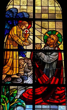 Photo for Kalety Miotek, Poland, January 1, 2023: Stained glass windows in the church of St. Francis, seen from the outside in the evening. Jesus in the garden of olives. - Royalty Free Image