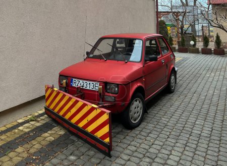 Photo for Rzeszow, Poland, February 8, 2022: An old very popular Fiat 126p passenger car adapted for shoveling snow is waiting for a snowfall. - Royalty Free Image