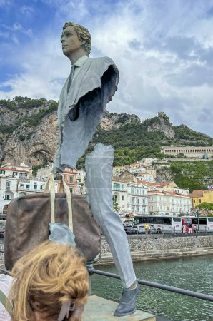 Photo for Amalfi, Salerno, Italy. September 26, 2023: "The travelers" of Bruno Catalano. The exhibition dedicated to the spiritual journey of everyone's life, but also to emigration. On the pier in Amalfi, Italy. - Royalty Free Image