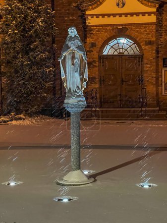 Photo for Parish church of St. Francis of Assisi in Kalety Miotek in winter, early in the morning during snowfall. - Royalty Free Image