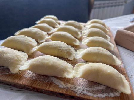 Home-made dumplings, kneading the dough by hand, rolling it, cutting it out and gluing it together.