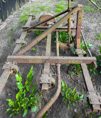 An old, home-made cultivator that has not been used for a long time.