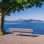 Empty bench on the edge of the lake in the old section of Zug, a beautiful city in Switzerland