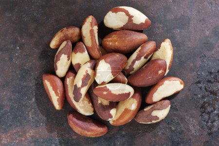 Close up on Brazil nuts on rusty metal background, top view 