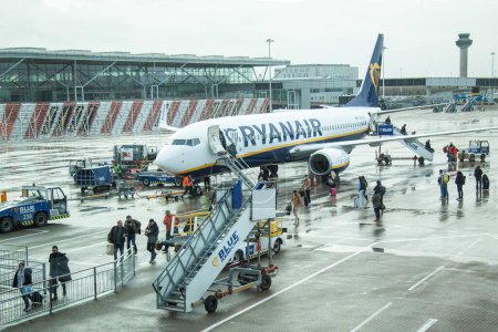 Photo for People leaving  Ryanair parked plane at Stansted airport. London, England -  January 1, 2023. - Royalty Free Image