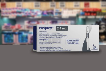 Photo for Packaging box of Wegovy (semaglutide) injectable prescription medication, weight-loss drug from Novo Nordisk A/S.  Blurred shop shelves in background. Copenhagen, Denmark - August 22, 2023. - Royalty Free Image