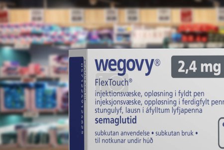 Photo for Packaging box of Wegovy (semaglutide) injectable prescription medication, weight-loss drug from Novo Nordisk A/S. Blurred shop shelves in background. Copenhagen, Denmark - August 14, 2023. - Royalty Free Image