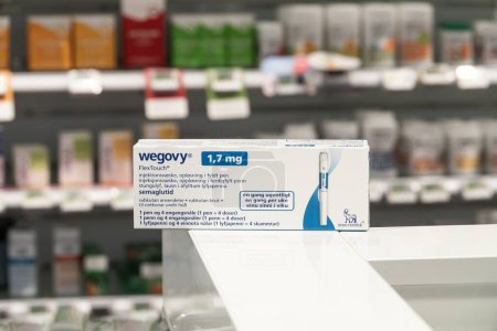 Photo for Packaging box of Wegovy (semaglutide) injectable prescription medication, weight-loss drug from Novo Nordisk AS. Pharmacy shop shelves in background. Copenhagen, Denmark - November 13, 2023. - Royalty Free Image