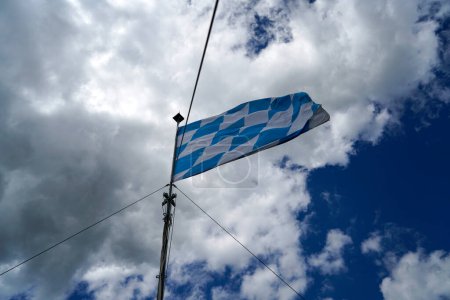 Photo for Flag flies against a blue white sky on a summer day in Bavaria - Royalty Free Image