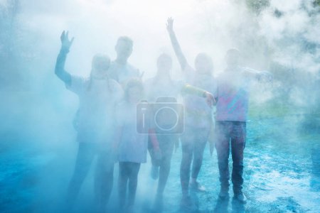 Photo for Group of happy people celebrating Holi with powder colors or gulal. Lying on the grass, top view. Concept of Indian festival Holi. - Royalty Free Image
