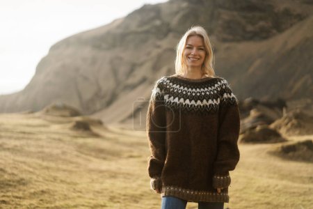 Photo for A girl in fashion clothes poses against a background of mountains - Royalty Free Image