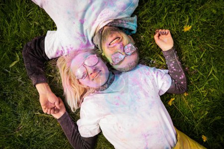 Photo for Portrait of a happy European couple celebrating Holi with powder colors or gulal. Concept of Indian festival Holi - Royalty Free Image
