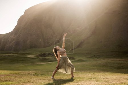 Photo for Girl dancing in a light dress at sunset in Iceland - Royalty Free Image
