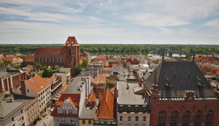 Photo for Aerial view on old view of the old town of Torun with the Vistula river in the background from the top of Town Hall tower . Torun, Poland. - Royalty Free Image