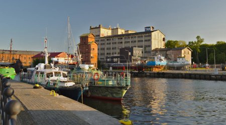 Photo for USTKA - JUNE 02,2023 : Fishing vessels and old factory buildings in harbor in Ustka in Poland - Royalty Free Image