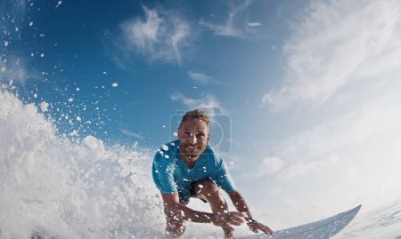 Photo for Happy surfer rides and smiles. Young man surfs the ocean wave in the Maldives and smiles - Royalty Free Image
