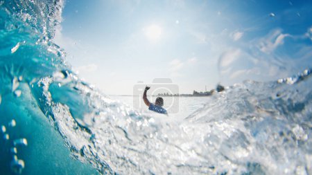 Photo for Girl surfer rides the wave. Woman surfs the ocean wave in the Maldives and falls - Royalty Free Image
