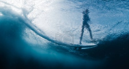 Photo for Underwater view of the surfer riding the wave in the Maldives - Royalty Free Image
