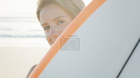 Photo for Woman surfer stands with surfing board on the tropical beach. Surfer's portrait - Royalty Free Image