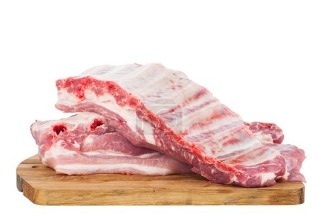Pork ribs on a wooden board isolated on a white background. Place for text. Copy space from above.